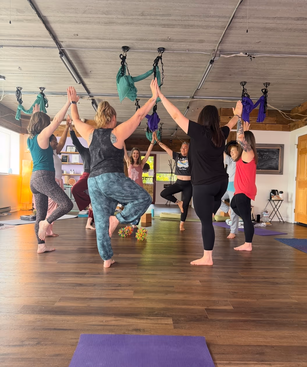 a small group practicing tree pose together at Inspired By Yoga in Hampstead